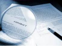 District Government Agencies Compliance Monitoring and Enforcement Fountain pen sitting on top of a business form document with a magnifying glass magnifying the text Contract